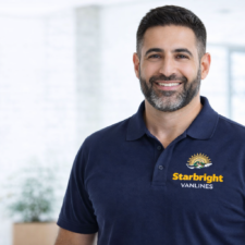 Starbright Vanlines team member with beard wearing a branded polo shirt and smiling confidently