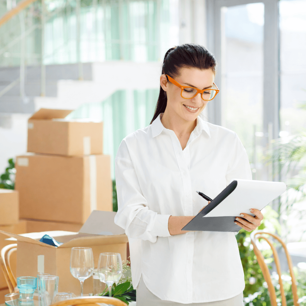 Moving Planning & Preparation Checklist – Starbright Vanlines Homeowner reviewing moving checklist during packing and move preparation with Starbright Vanlines